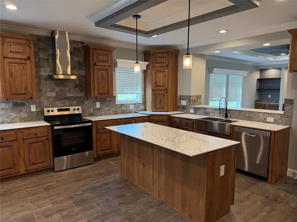 a kitchen with a sink stove and cabinets