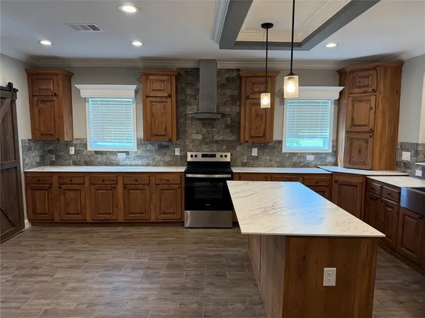 a kitchen with a sink refrigerator and cabinets