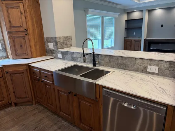 a kitchen with a sink cabinets and a window