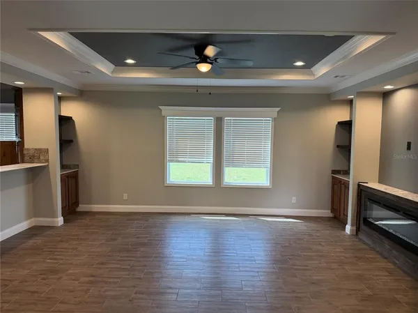an empty room with wooden floor and a window