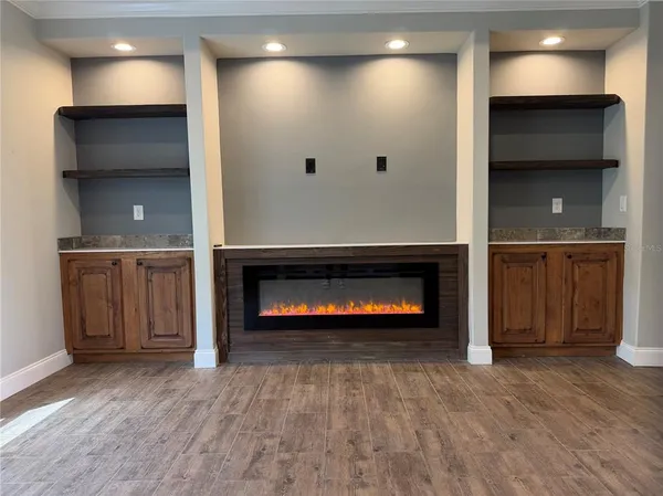 a view of an empty room and fire place