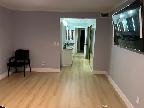 a view of a room with wooden floor and furniture