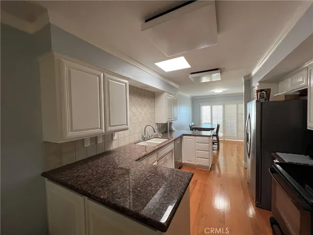 a large kitchen with a center island and stainless steel appliances