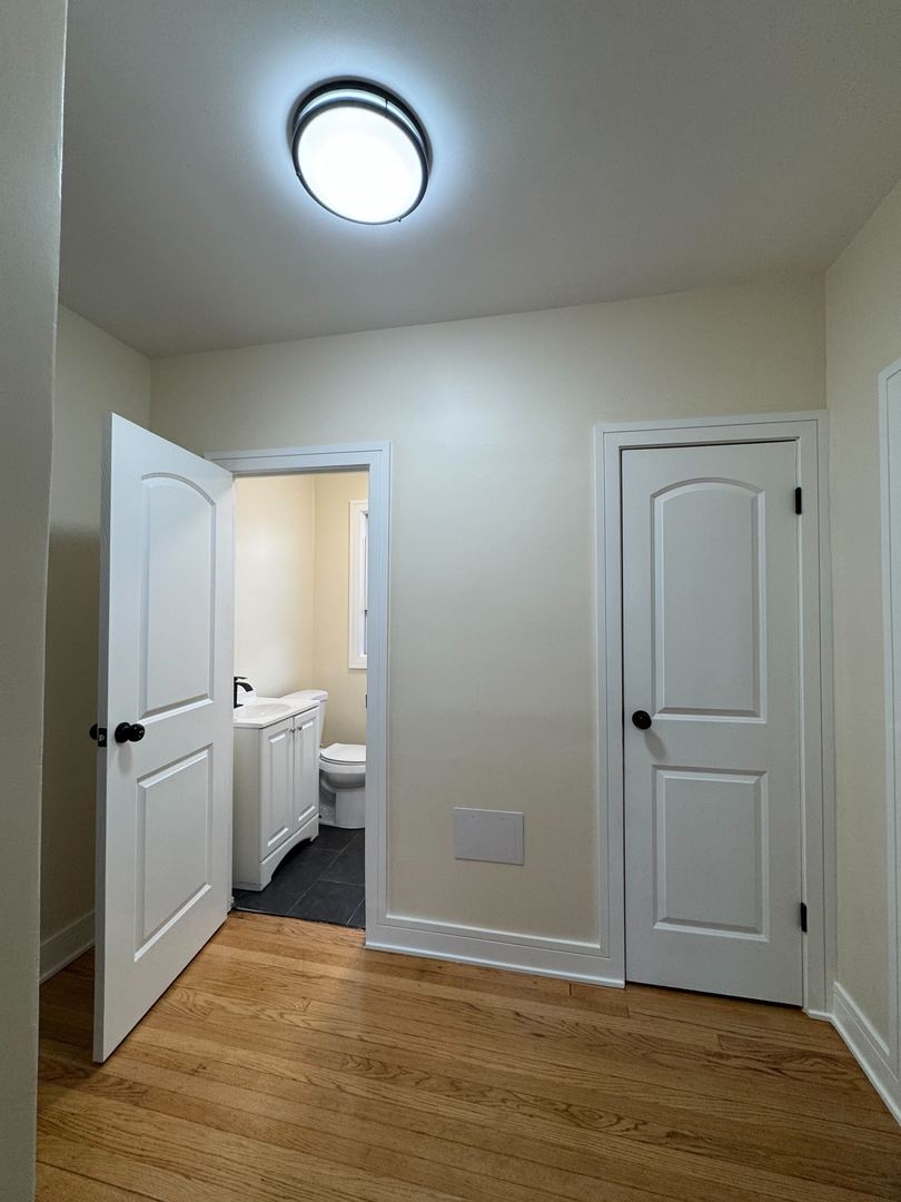 610 East 74th Street, Unit 2B Chicago, IL 60619 - Photo 4 of 10 a view of a room with wooden floor and window