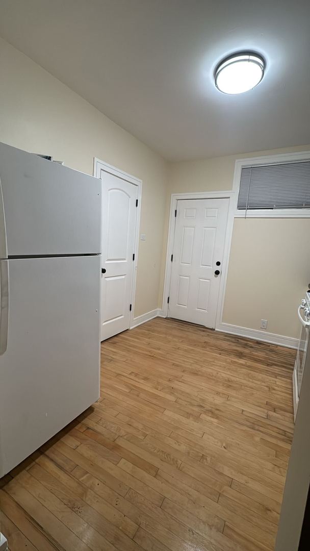 610 East 74th Street, Unit 2B Chicago, IL 60619 - Photo 6 of 10 a view of empty room with window and refrigerator