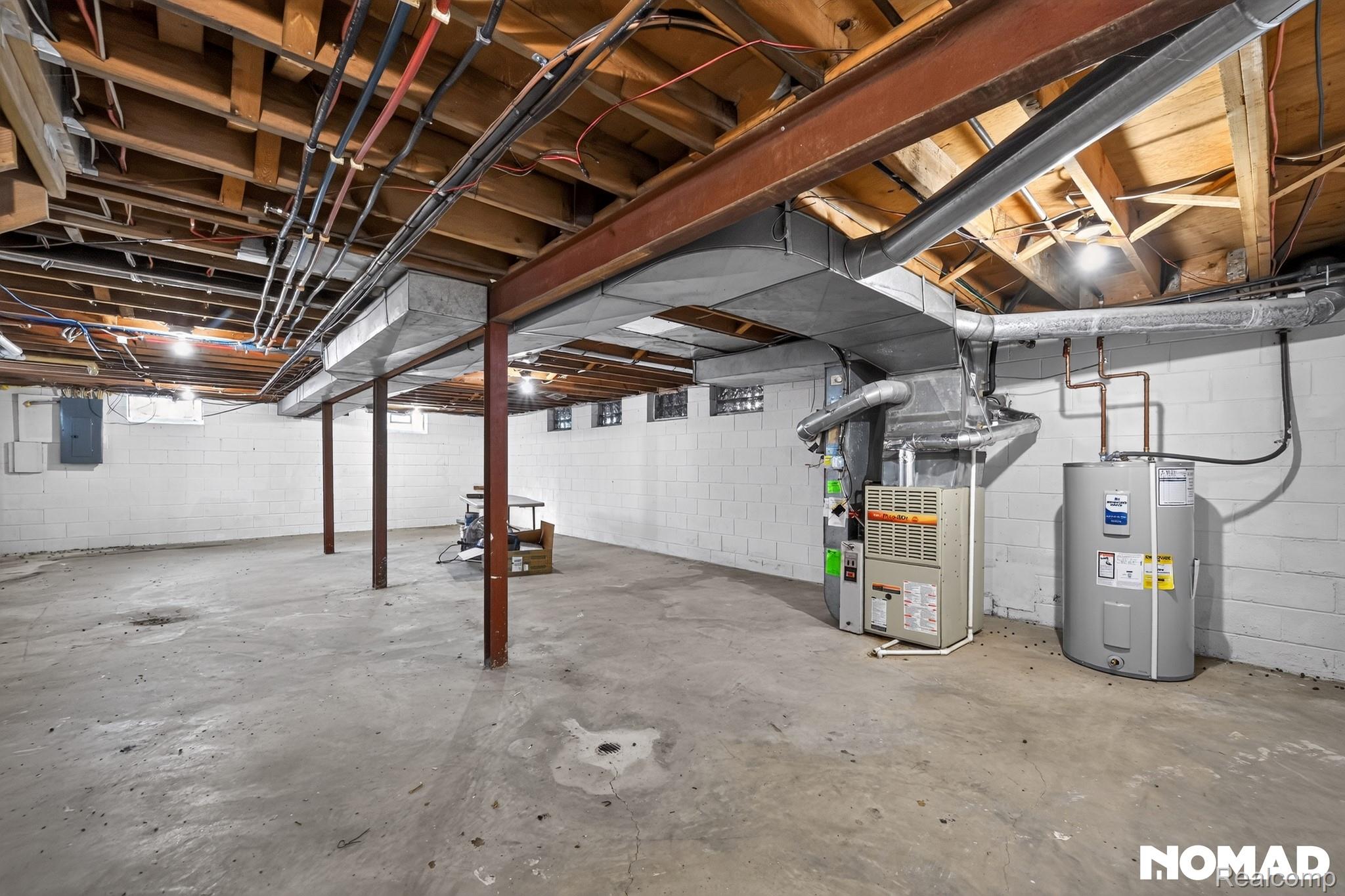 8315 Hilton Road Brighton, MI 48114 - Photo 19 of 26 Spacious unfinished basement featuring concrete flooring and exposed ceiling joists