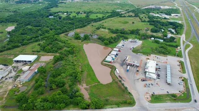 an aerial view of a house with a yard and lake view
