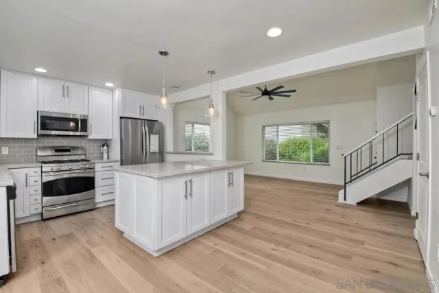 a kitchen with granite countertop a stove top oven and sink