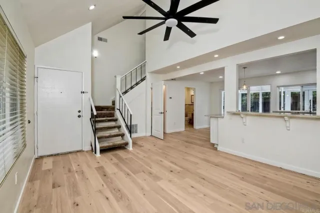 a view of an entryway with wooden floor and staircase