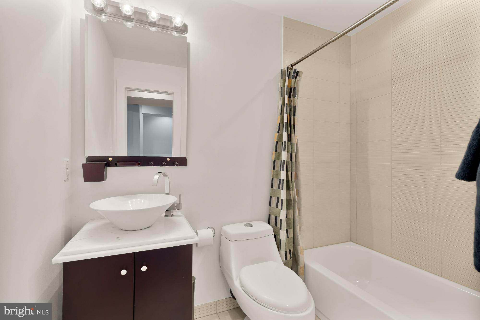 1409 G Street Northeast, Unit 5 Washington, DC 20002 - Photo 24 of 29 a bathroom with a toilet a sink and bathtub