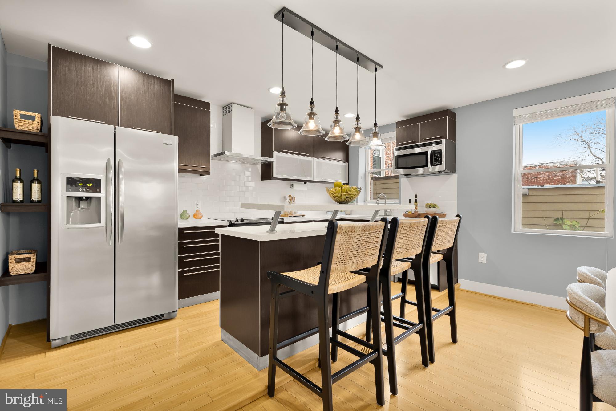 1409 G Street Northeast, Unit 5 Washington, DC 20002 - Photo 6 of 29 a kitchen with stainless steel appliances kitchen island granite countertop a refrigerator and microwave