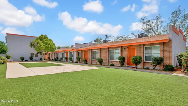 a front view of a house with a yard table and chairs
