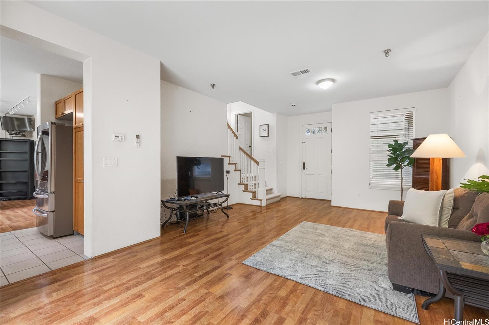 520 Lunalilo Home Road, Unit 313 Honolulu, HI 96825 - Photo 11 of 25 a living room with furniture and a wooden floor