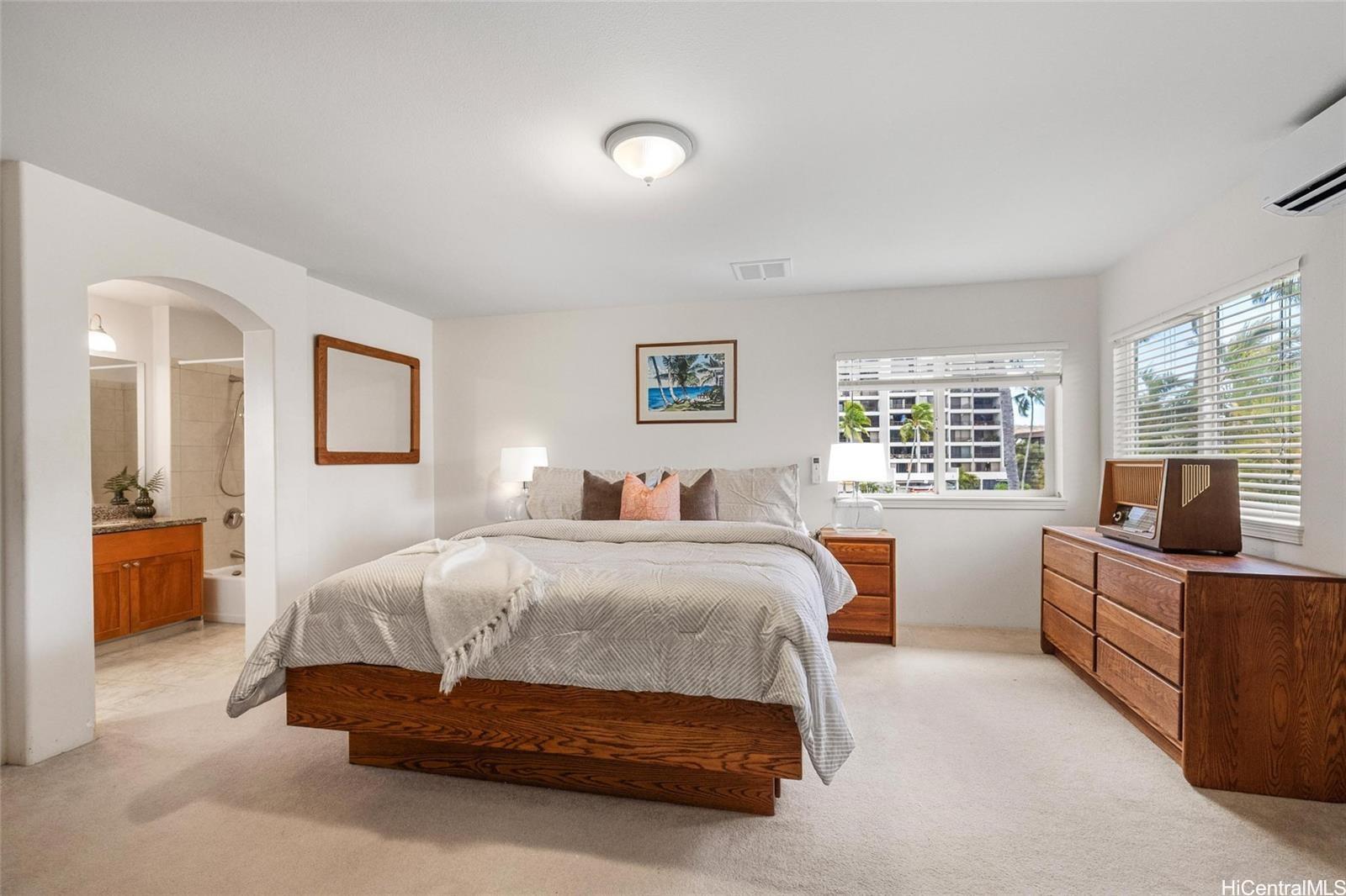 520 Lunalilo Home Road, Unit 313 Honolulu, HI 96825 - Photo 15 of 25 a bedroom with a bed and furniture