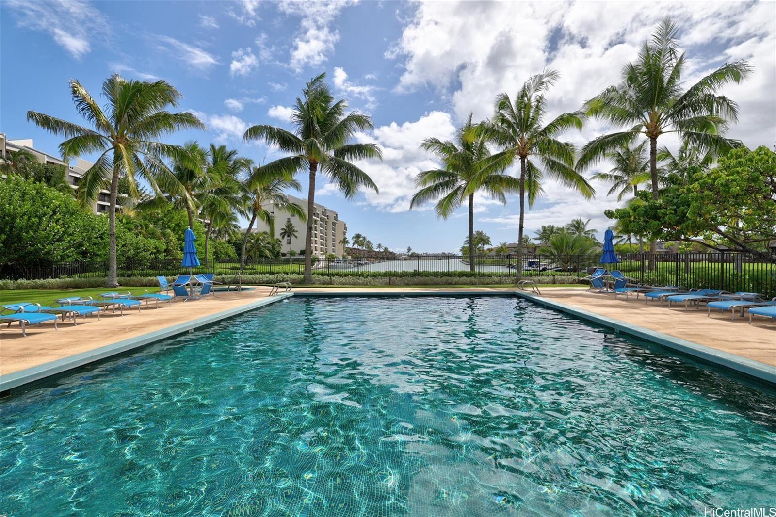 520 Lunalilo Home Road, Unit 313 Honolulu, HI 96825 - Photo 23 of 25 a view of swimming pool with a yard and palm trees