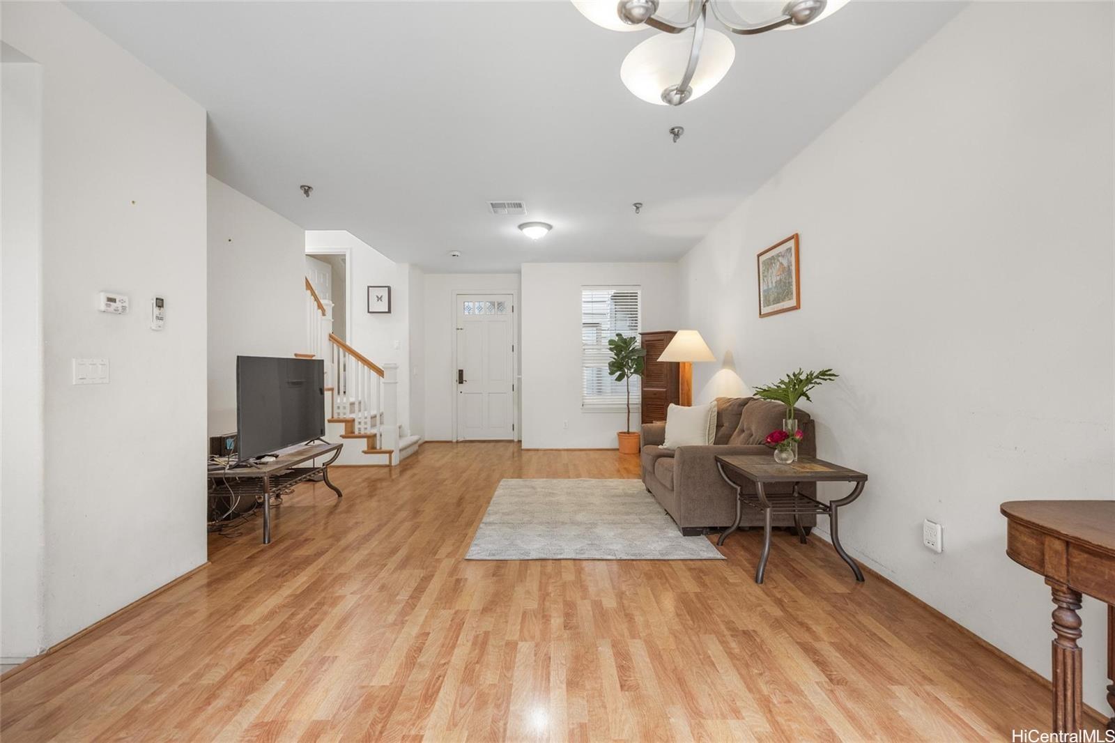 520 Lunalilo Home Road, Unit 313 Honolulu, HI 96825 - Photo 5 of 25 a living room with furniture and a wooden floor