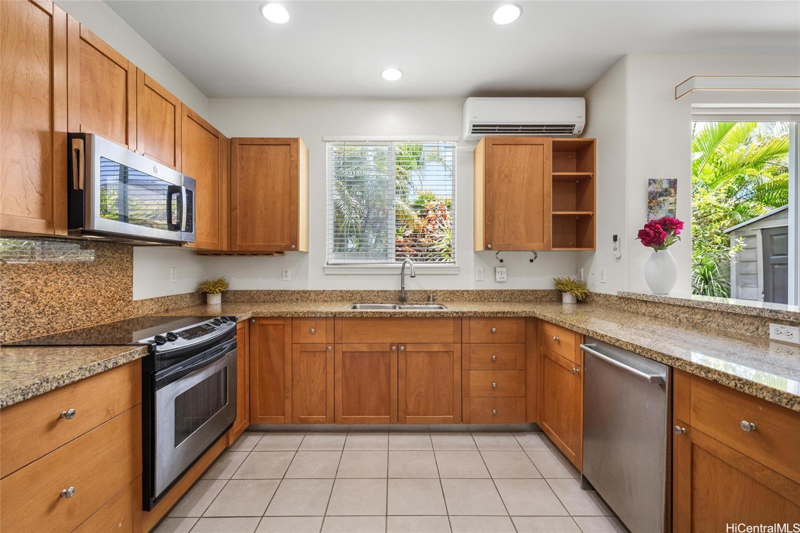520 Lunalilo Home Road, Unit 313 Honolulu, HI 96825 - Photo 7 of 25 a kitchen with stainless steel appliances granite countertop a sink and a stove
