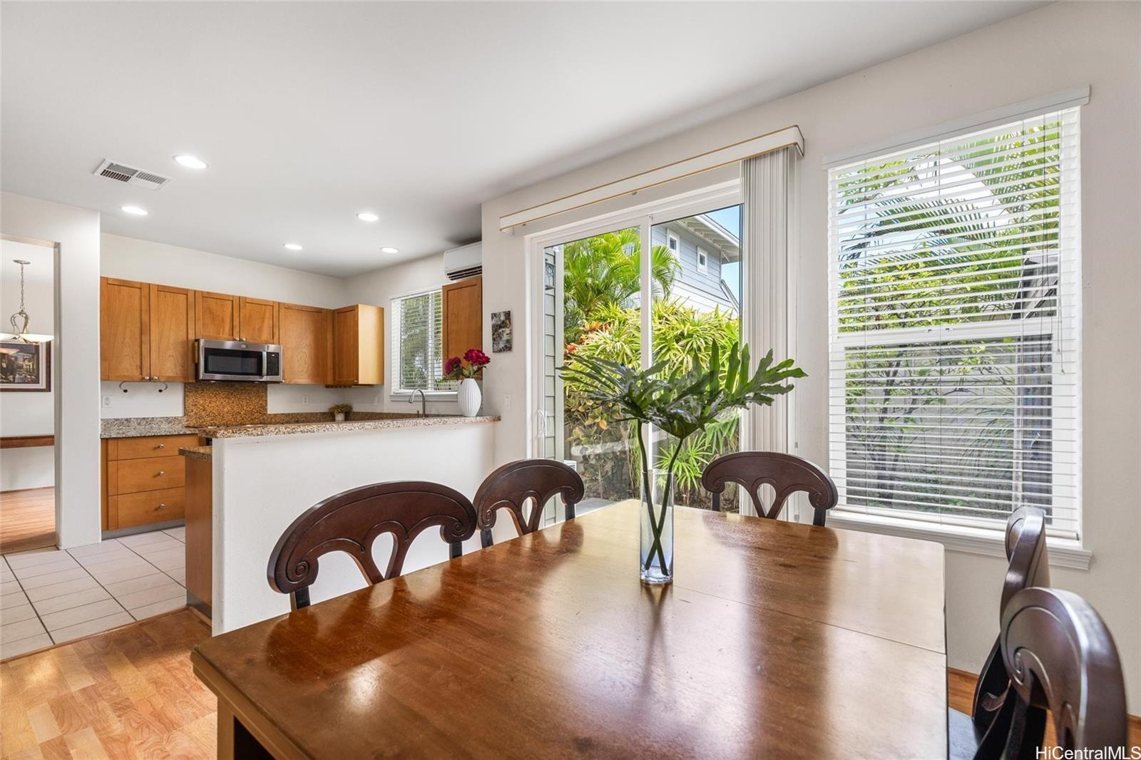 520 Lunalilo Home Road, Unit 313 Honolulu, HI 96825 - Photo 9 of 25 a living room with stainless steel appliances furniture a large window and a wooden floor