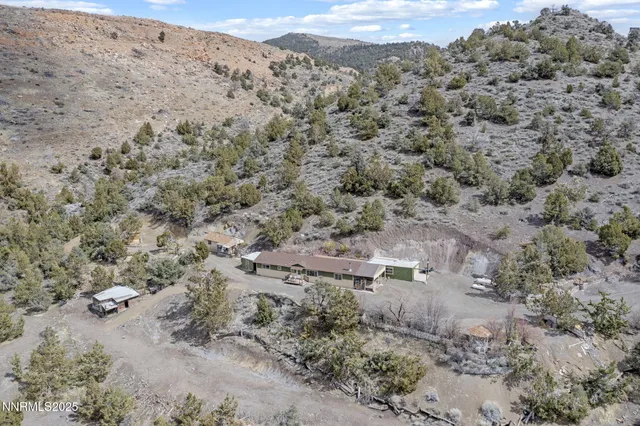 an aerial view of a house with yard and outdoor seating
