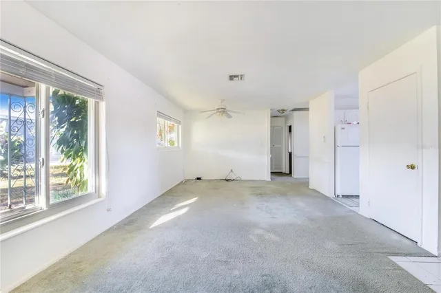 a kitchen with a sink a stove top oven and white stainless steel appliances