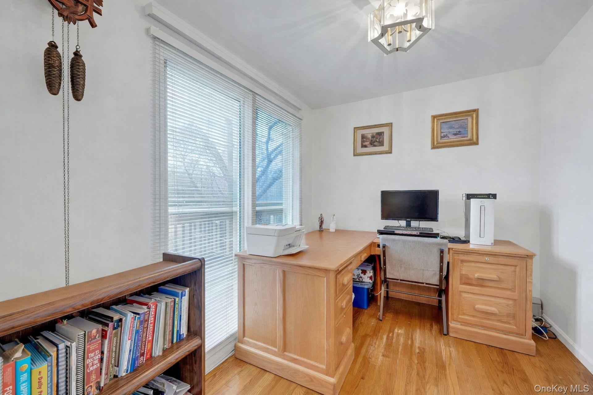 97 Bradley Road Scarsdale, NY 10583 - Photo 12 of 27 a view of a workspace with furniture and a bookshelf