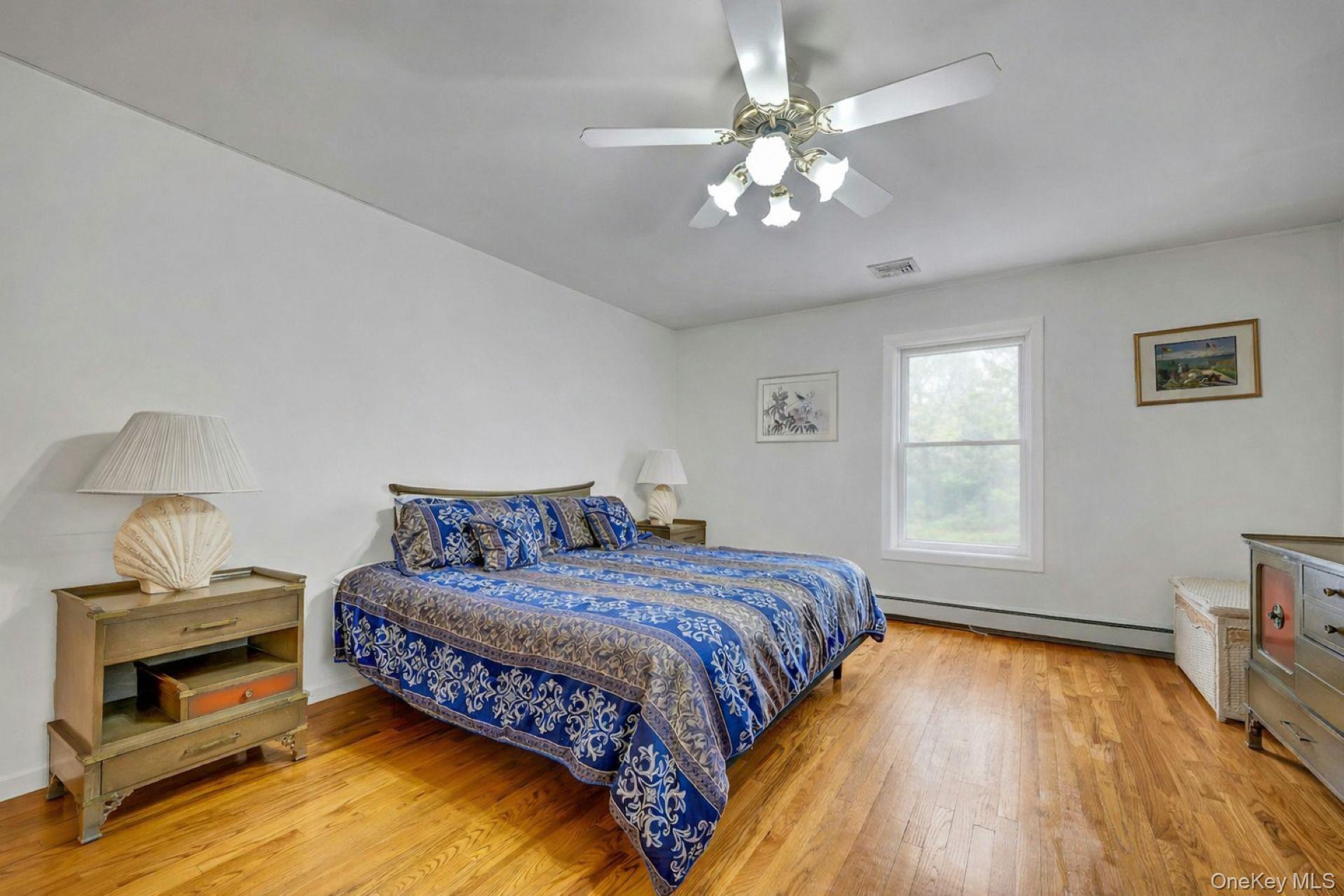 97 Bradley Road Scarsdale, NY 10583 - Photo 13 of 27 a bedroom with a bed and a chandelier