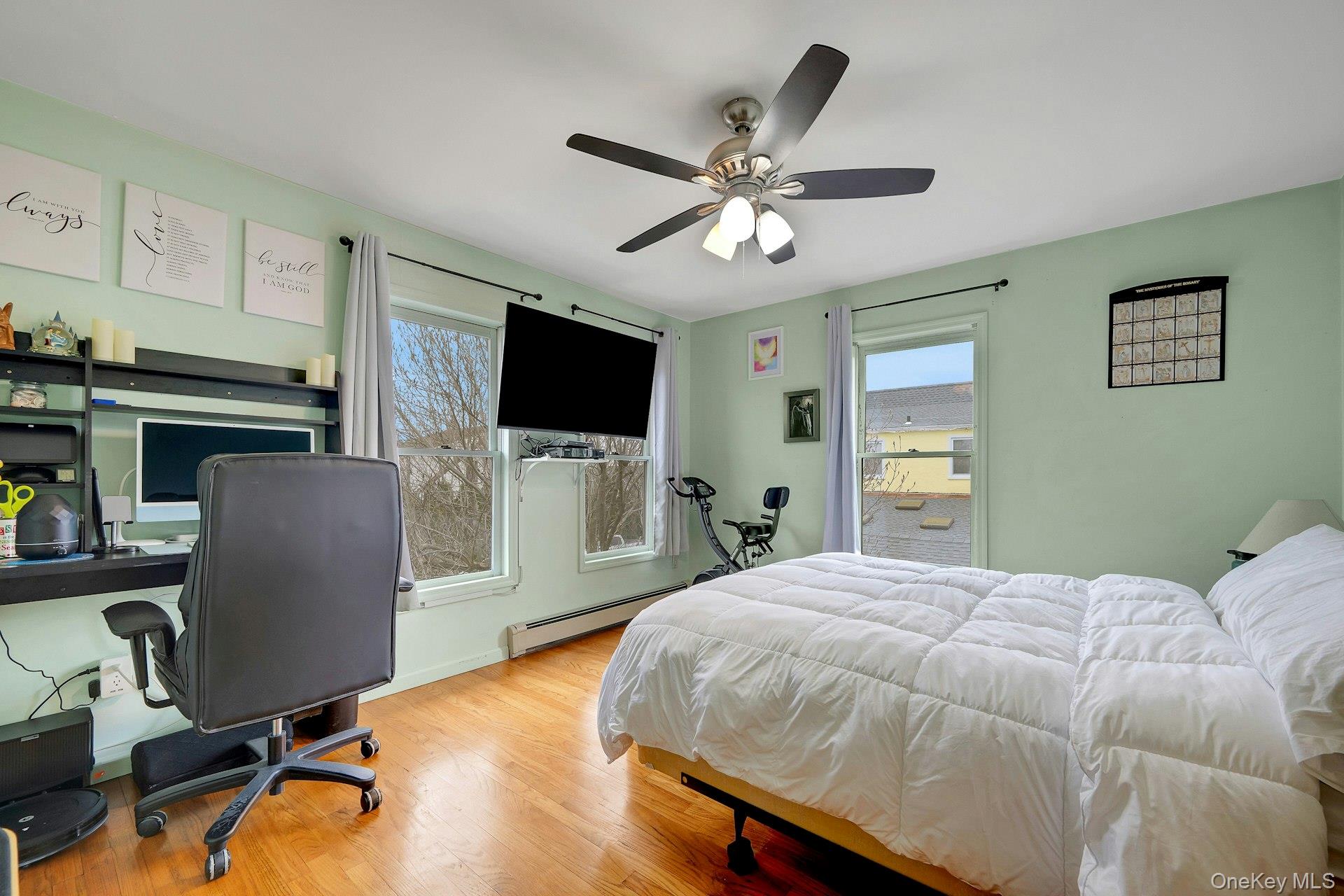 97 Bradley Road Scarsdale, NY 10583 - Photo 19 of 27 a bedroom with a bed and flat screen tv