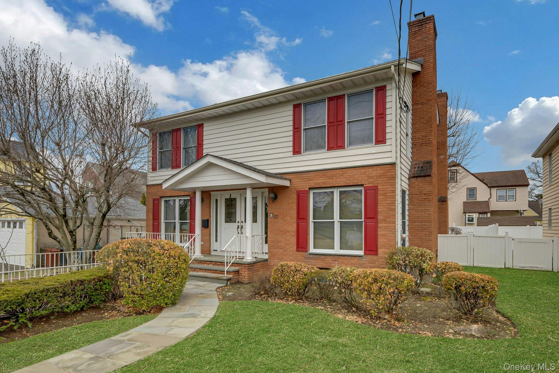 97 Bradley Road Scarsdale, NY 10583 - Photo 2 of 27 front view of a house with a yard