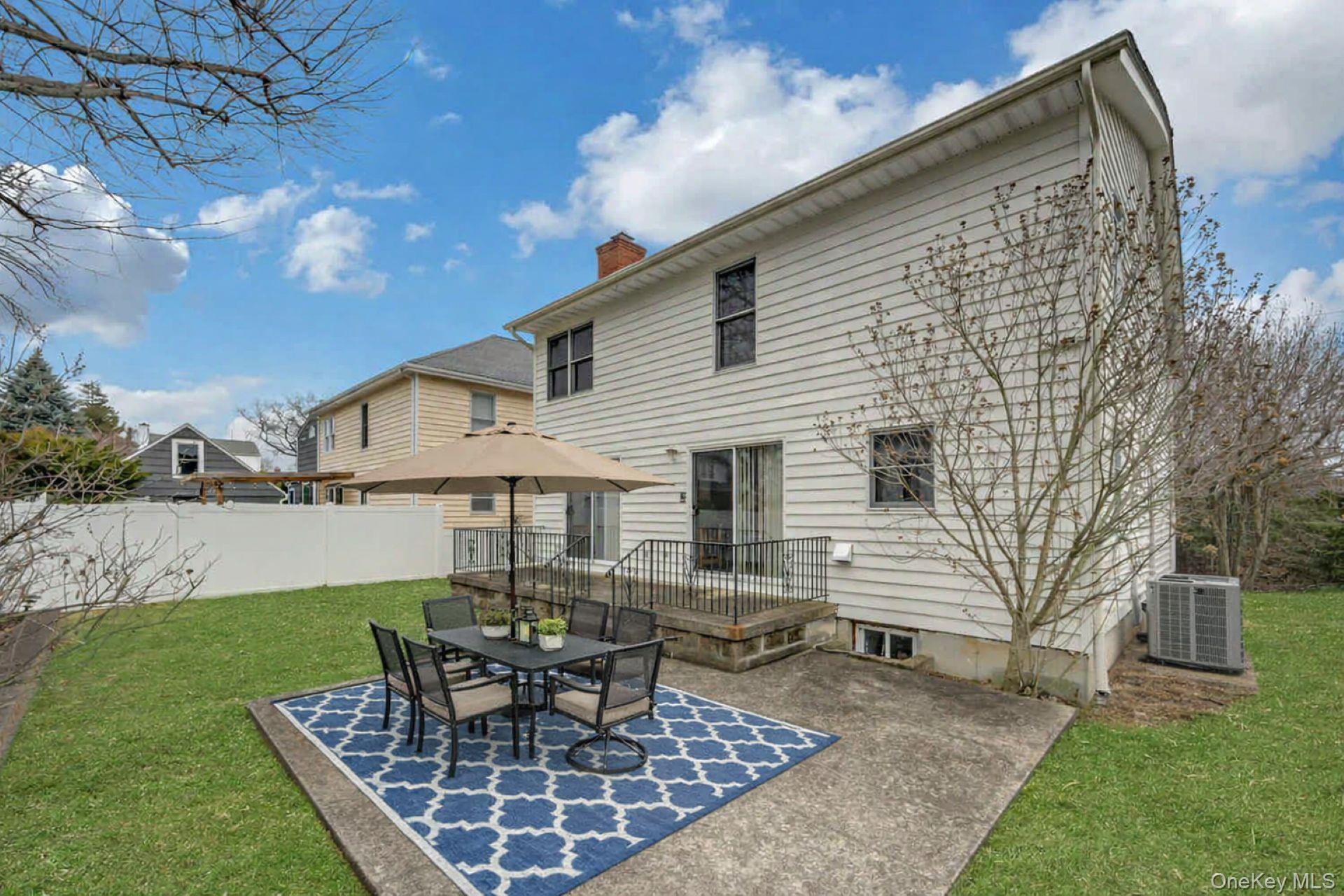 97 Bradley Road Scarsdale, NY 10583 - Photo 24 of 27 a view of a house with backyard and sitting area