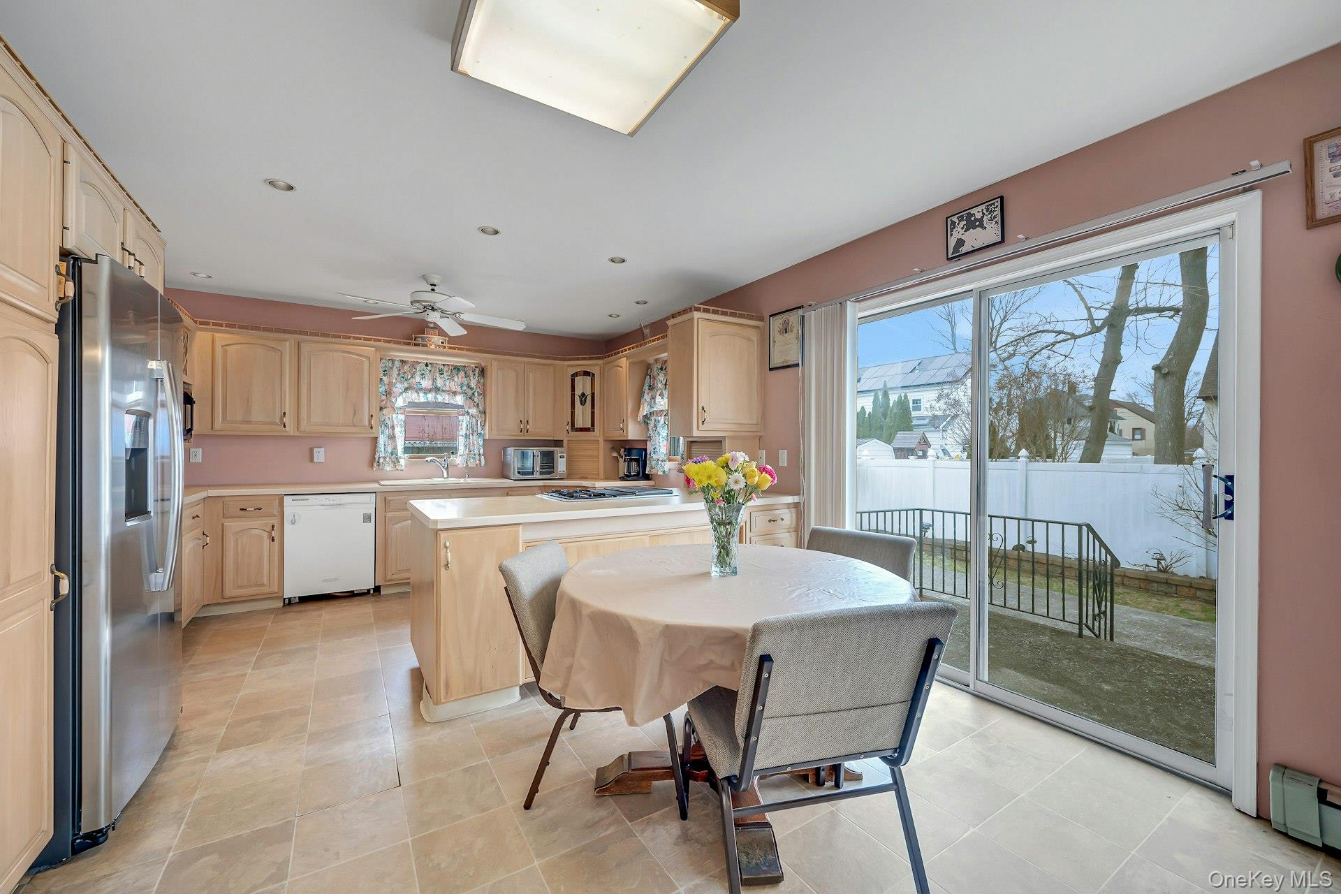 97 Bradley Road Scarsdale, NY 10583 - Photo 9 of 27 a dining area with a table chairs and a kitchen view