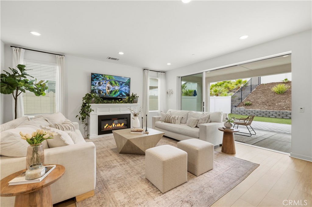 18135 Tableau Way Saugus, CA 91350 - Photo 6 of 43 great room with full wall sliding door open to outdoor living space