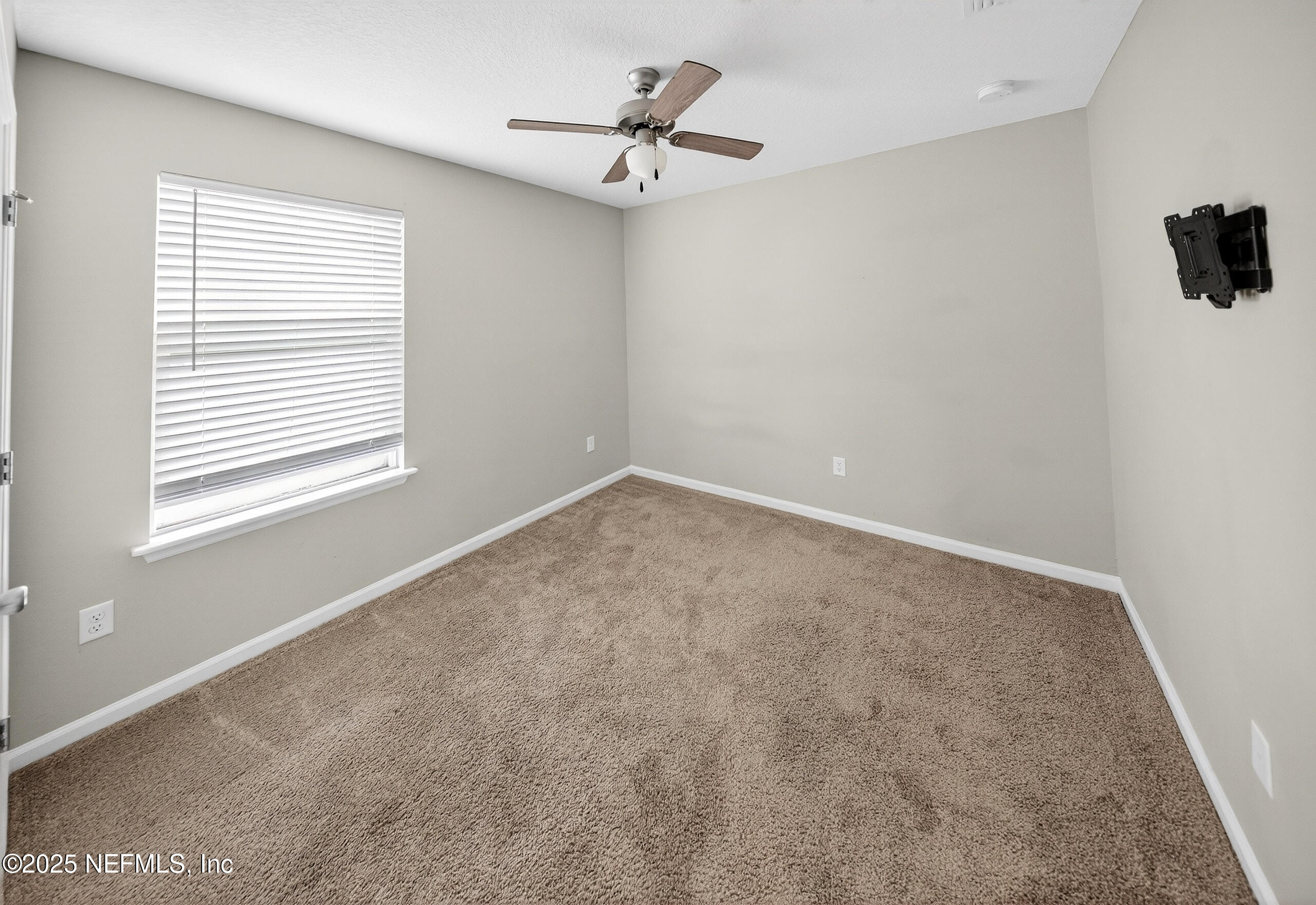 9810 Fiddleback Lane Jacksonville, FL 32222 - Photo 12 of 20 an empty room with a window and a fan