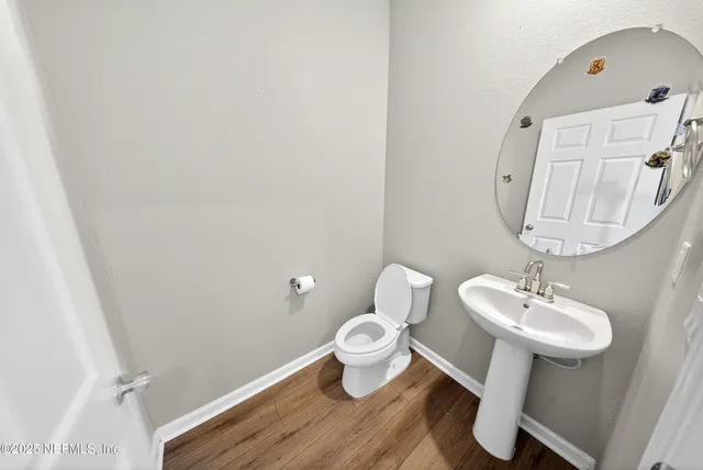 a bathroom with a sink mirror and toilet