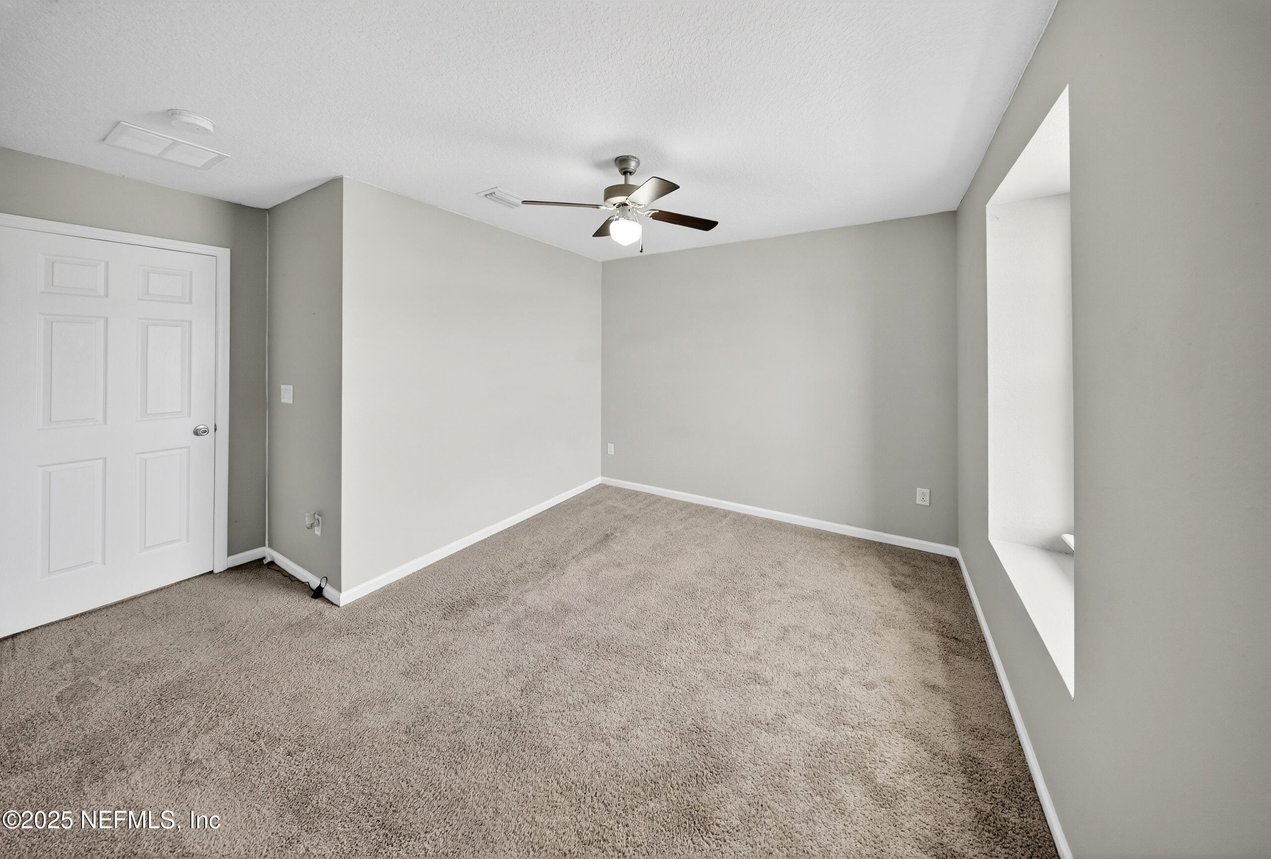 9810 Fiddleback Lane Jacksonville, FL 32222 - Photo 9 of 20 wooden floor in an empty room with a window