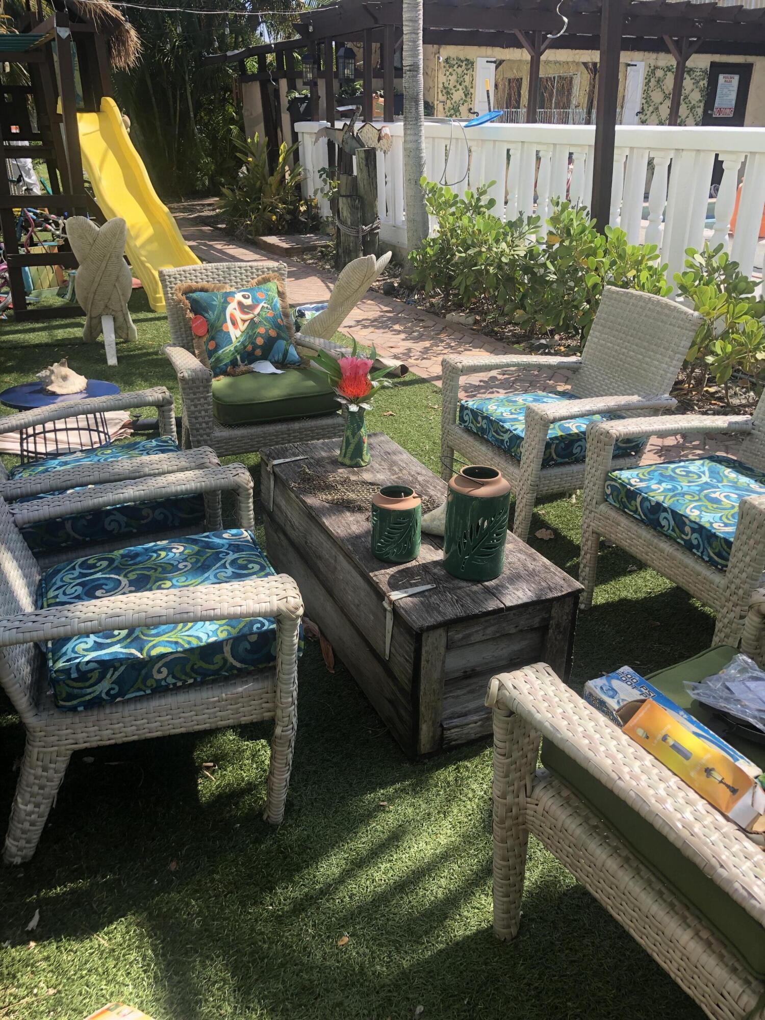735 Hummingbird Way, Unit 202 North Palm Beach, FL 33408 - Photo 15 of 15 a view of a backyard with sitting area