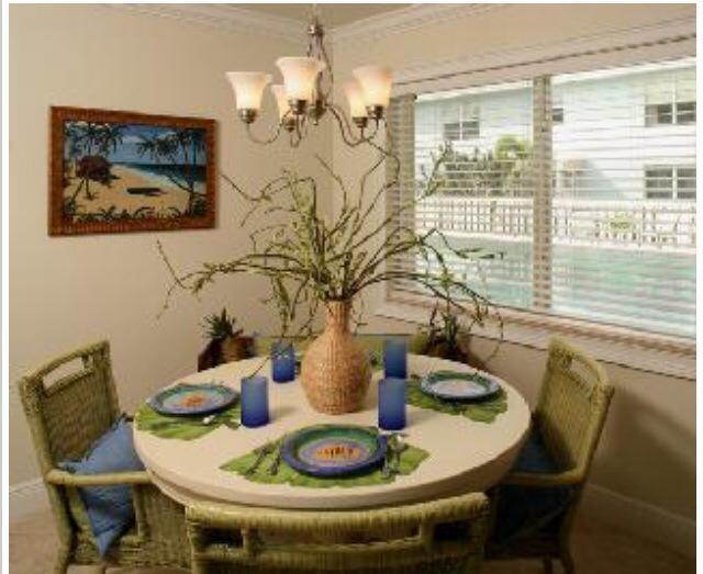 735 Hummingbird Way, Unit 202 North Palm Beach, FL 33408 - Photo 4 of 15 a dining room with furniture and wooden floor