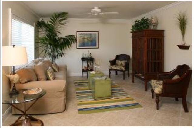 735 Hummingbird Way, Unit 202 North Palm Beach, FL 33408 - Photo 6 of 15 a living room with furniture and a potted plant