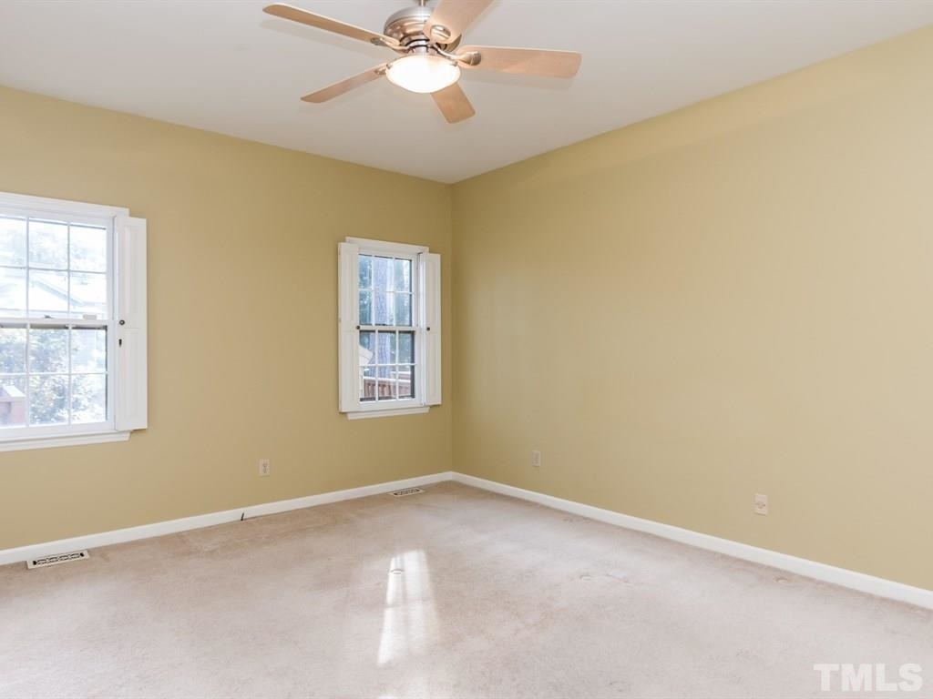 934 Albany Court Raleigh, NC 27615 - Photo 14 of 25 an empty room with windows and fan