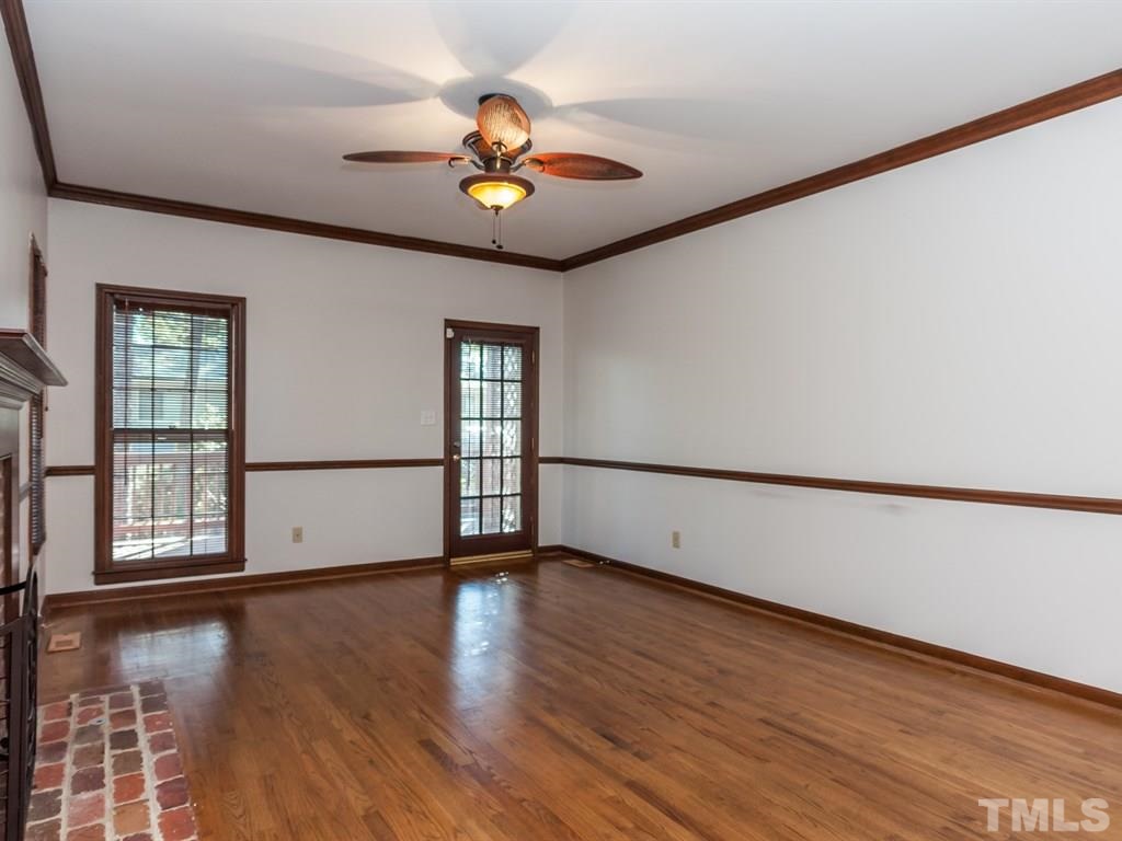 934 Albany Court Raleigh, NC 27615 - Photo 5 of 25 a view of an empty room with wooden floor and a window