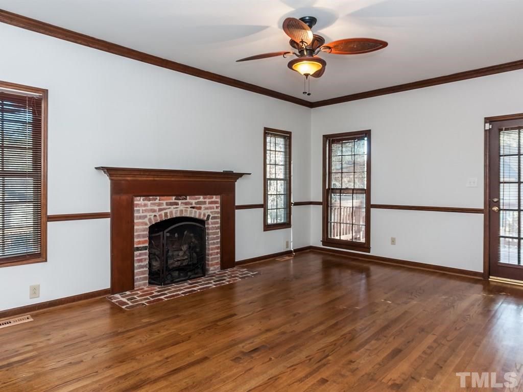 934 Albany Court Raleigh, NC 27615 - Photo 6 of 25 a view of empty room with wooden floor and fan