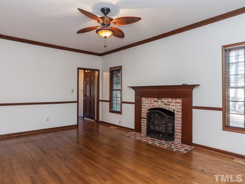 934 Albany Court Raleigh, NC 27615 - Photo 7 of 25 an empty room with windows and fireplace