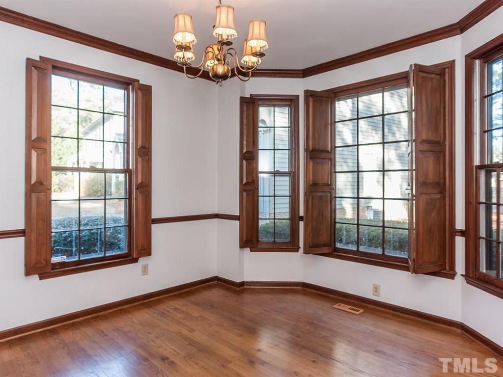 934 Albany Court Raleigh, NC 27615 - Photo 8 of 25 a view of an empty room with a window and wooden floor