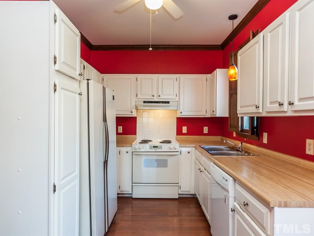 934 Albany Court Raleigh, NC 27615 - Photo 10 of 25 a kitchen with stainless steel appliances granite countertop a stove and a refrigerator