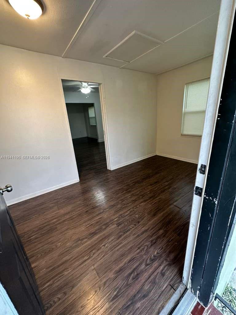 920 Northwest 22nd Court, Unit 920 Miami, FL 33125 - Photo 4 of 28 a view of an empty room with wooden floor and staircase
