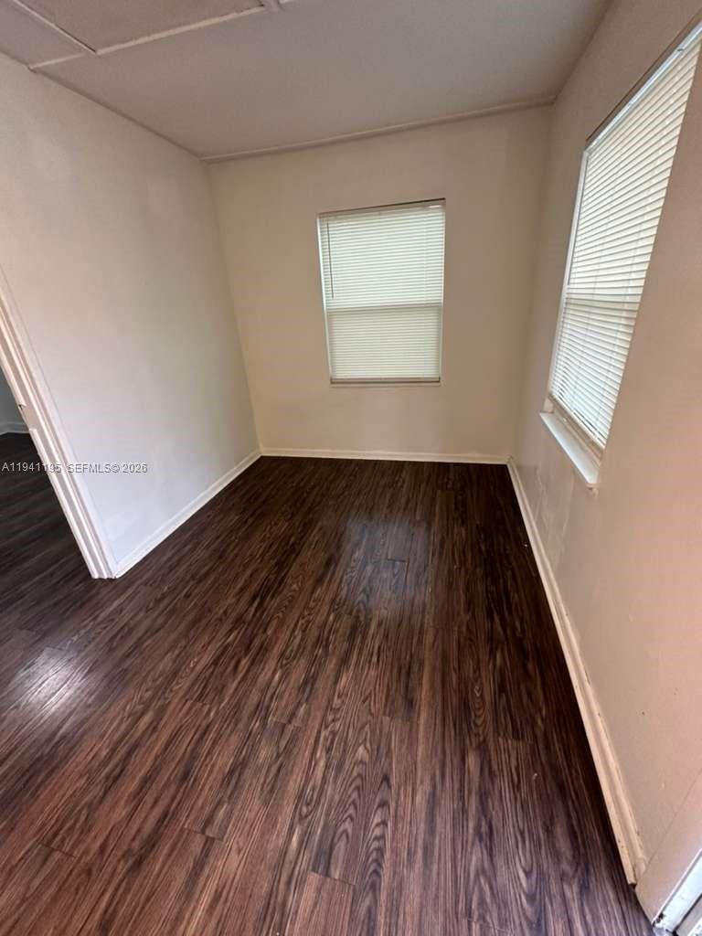 920 Northwest 22nd Court, Unit 920 Miami, FL 33125 - Photo 5 of 28 an empty room with wooden floor and windows