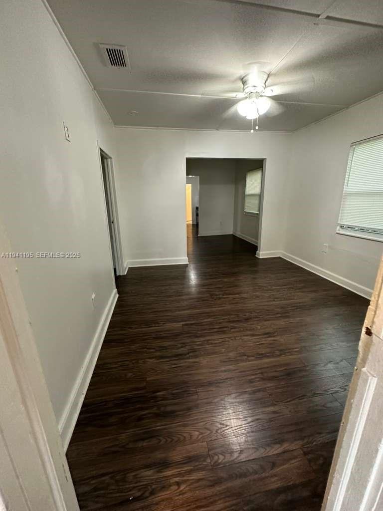 920 Northwest 22nd Court, Unit 920 Miami, FL 33125 - Photo 6 of 28 a view of an empty room with wooden floor and staircase