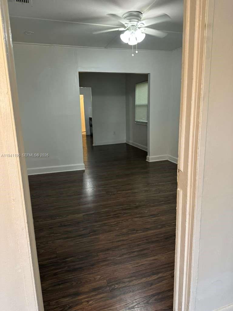 920 Northwest 22nd Court, Unit 920 Miami, FL 33125 - Photo 7 of 28 a view of an empty room with wooden floor and staircase