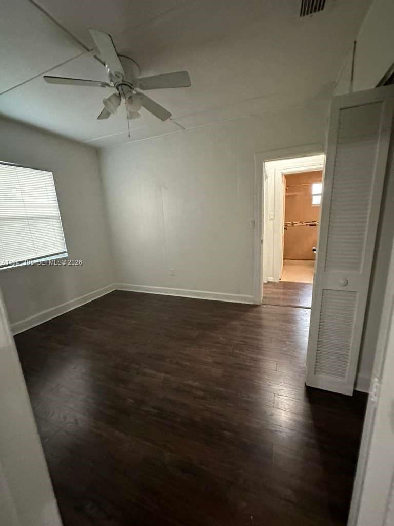 920 Northwest 22nd Court, Unit 920 Miami, FL 33125 - Photo 9 of 28 an empty room with wooden floor and windows