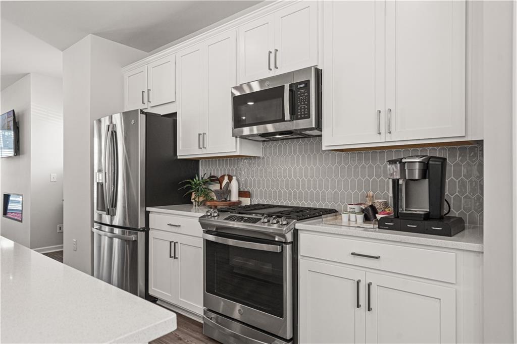 66 Wilder Ridge Way Lawrenceville, GA 30044 - Photo 11 of 44 a kitchen with stainless steel appliances granite countertop a refrigerator stove and microwave