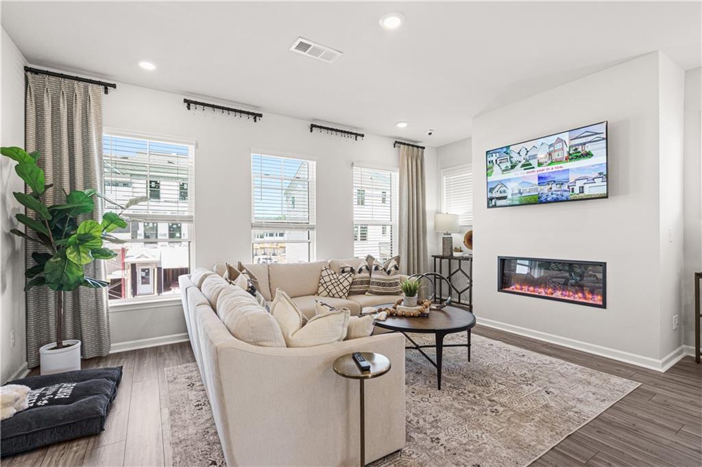 66 Wilder Ridge Way Lawrenceville, GA 30044 - Photo 18 of 44 a living room with furniture a potted plant and a large window